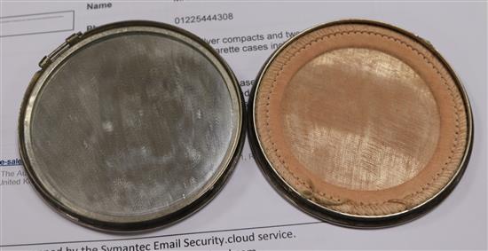Two silver compacts and two engine turned silver cigarette cases including one modelled as a book.
